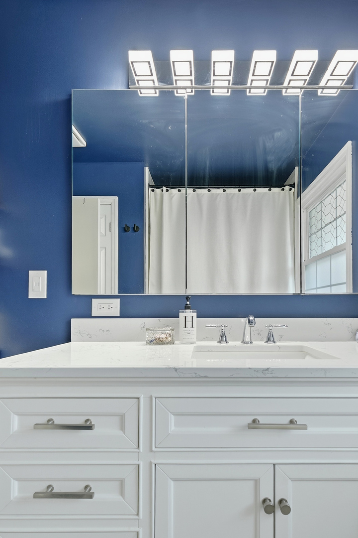 1700 46th Street Moline, IL 61265 - Photo 37 of 45 a bathroom with a sink vanity and mirror
