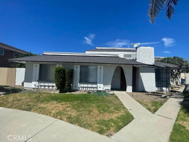17061 Grove Circle, Unit 4 Huntington Beach, CA 92647 - Photo 1 of 15 a view of a house with a yard and plants