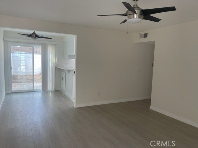 17061 Grove Circle, Unit 4 Huntington Beach, CA 92647 - Photo 6 of 15 an empty room with wooden floor and windows