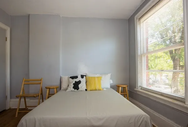 a bedroom with a bed and window