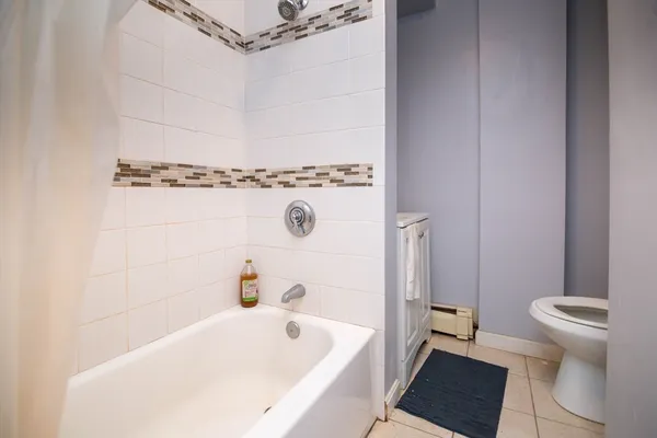 a bathroom with a bathtub and a toilet