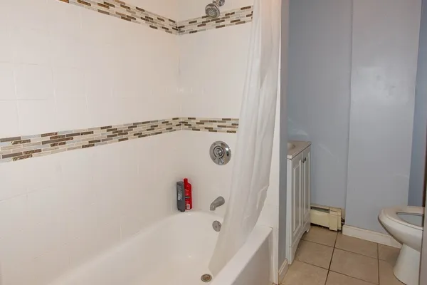 a bathroom with a shower and a toilet