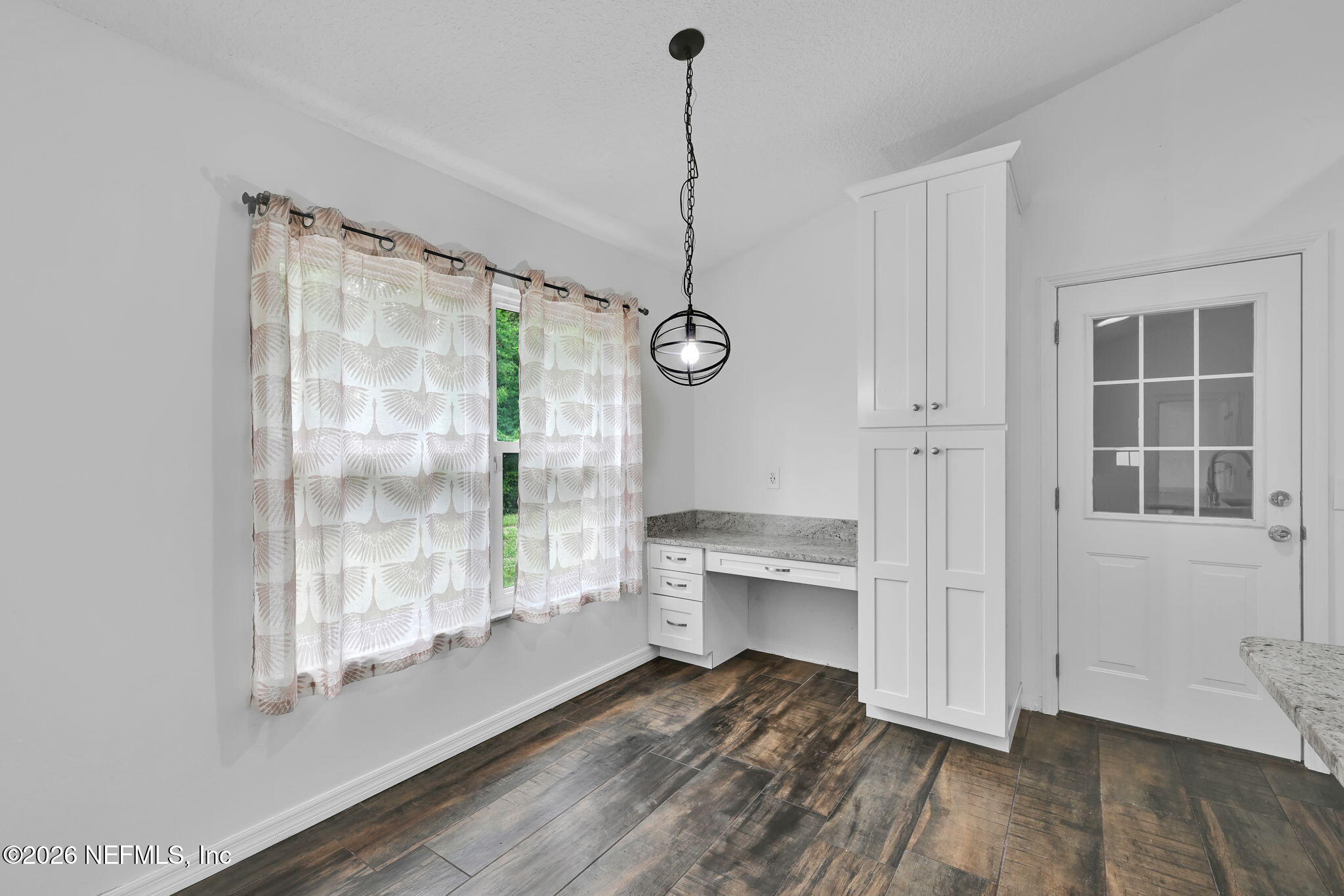 1110 Woodlawn Road, Unit D St. Augustine, FL 32084 - Photo 22 of 40 a view of an empty room with wooden floor and a window