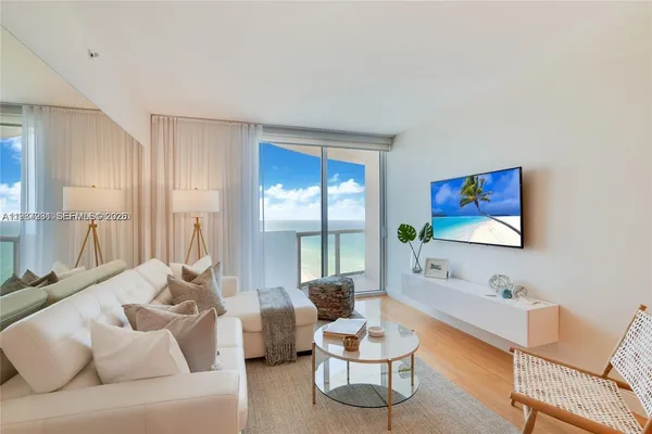 a living room with furniture and a large window