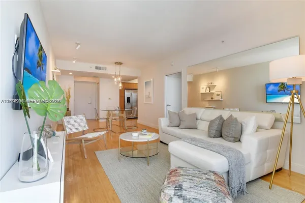 a living room with furniture and a lamp