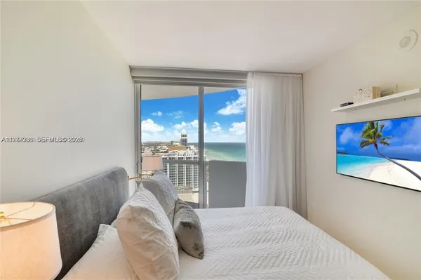 a bedroom with a bed and a painting on the wall