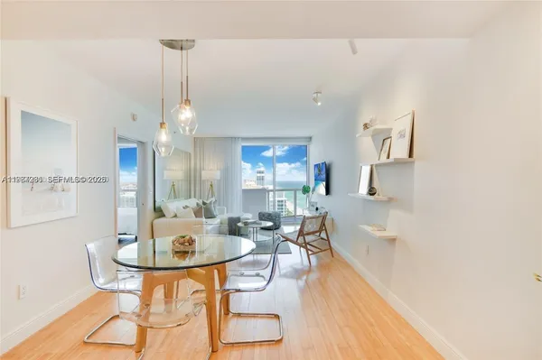 a view of a dining room with furniture and wooden floor