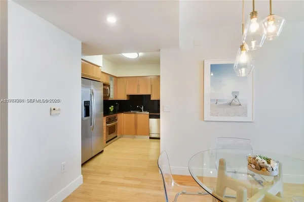 a view of kitchen and dining area with chandelier