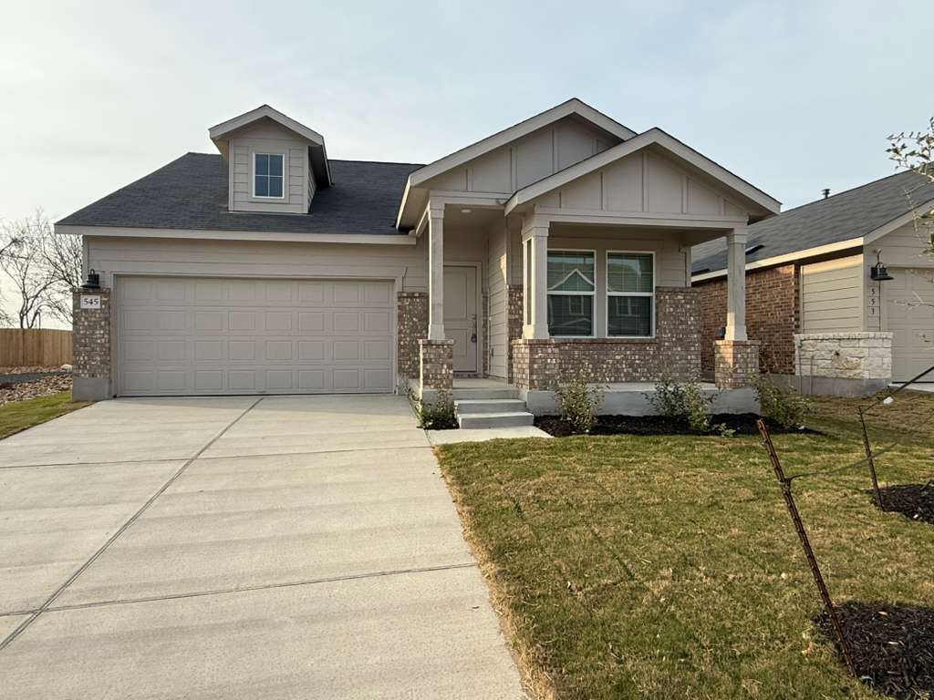 545 Sormonne Loop Kyle, TX 78640 - Photo 4 of 39 Craftsman-style home with brick siding, driveway, a garage, and a front lawn