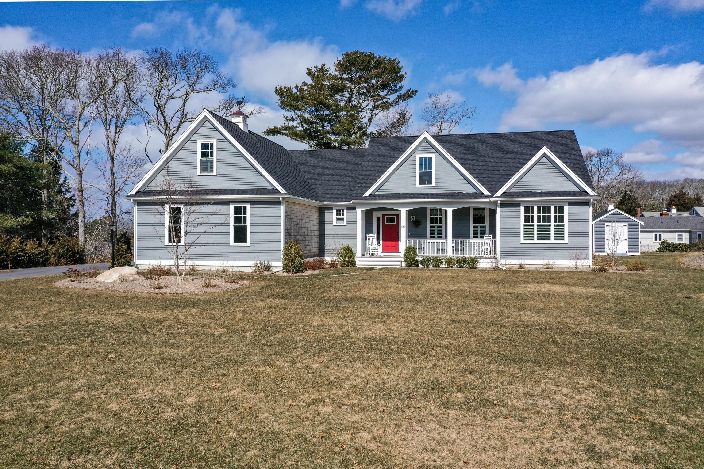 127 Elgin Road Pocasset, MA 02559 - Photo 2 of 40 a front view of a house with a garden