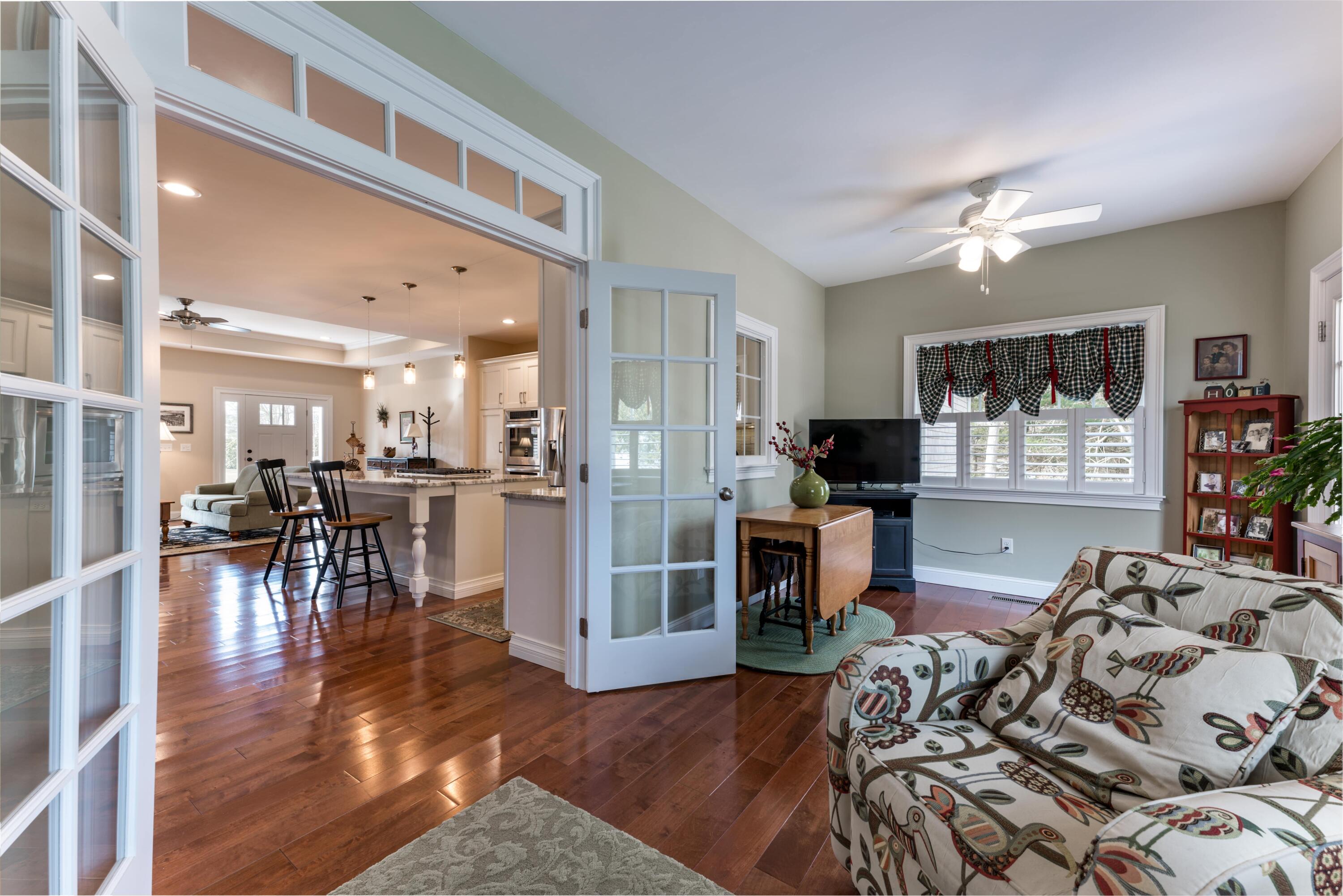 127 Elgin Road Pocasset, MA 02559 - Photo 26 of 40 a living room with furniture and a wooden floor