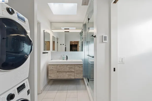 a en suite bathroom with a sink a mirror and bathtub