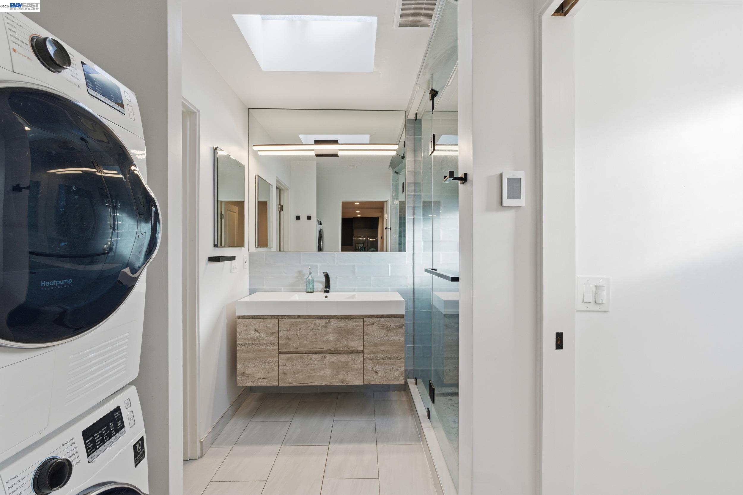 820 46th Street Oakland, CA 94608 - Photo 11 of 34 a en suite bathroom with a sink a mirror and bathtub