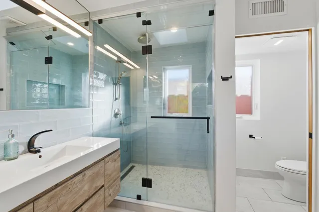 a view of a balcony with wooden floor and iron fence