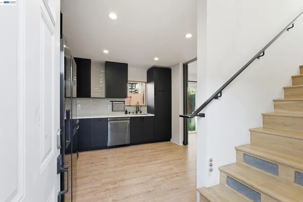 a kitchen with stainless steel appliances kitchen island granite countertop refrigerator sink and stove