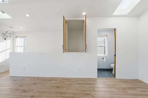a view of a room with wooden floor and cabinet