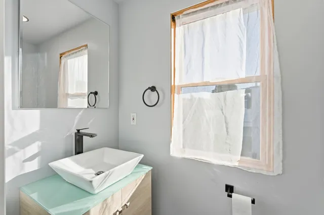 an aerial view of a house with a yard basket ball court and outdoor seating