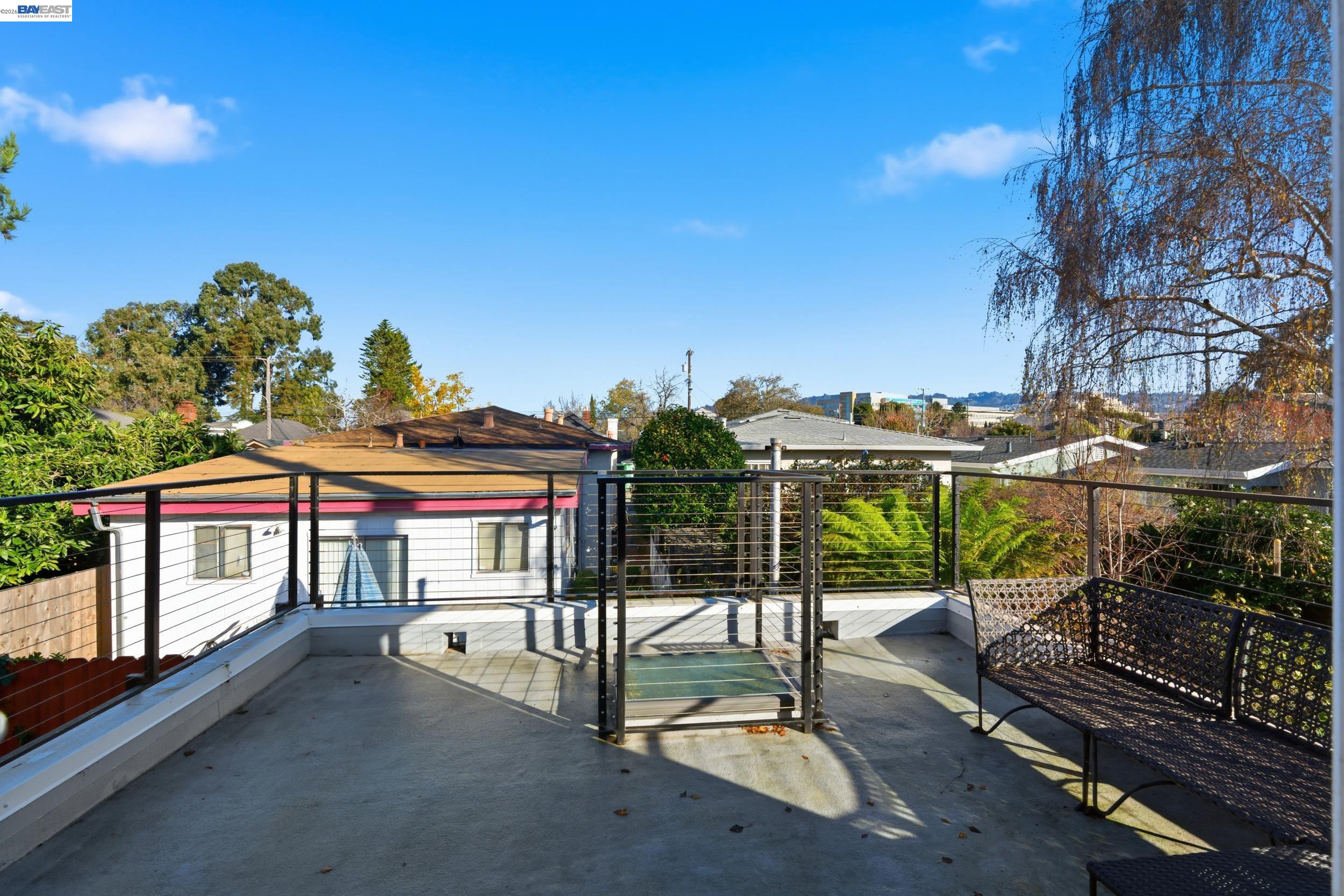 820 46th Street Oakland, CA 94608 - Photo 20 of 34 a view of a balcony with wooden floor and iron fence