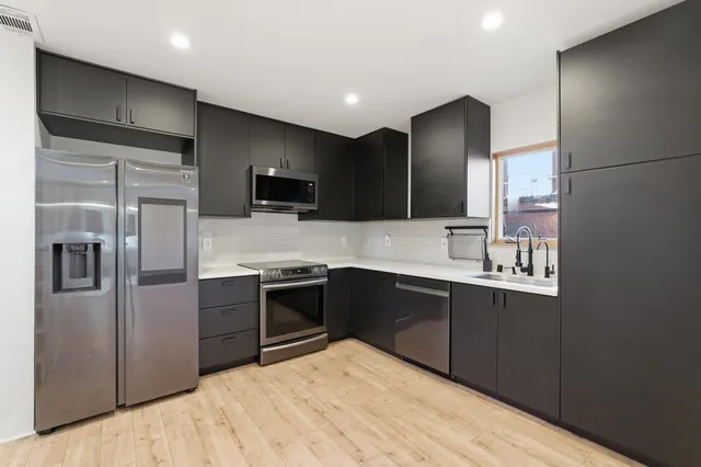 a kitchen with a sink and a window