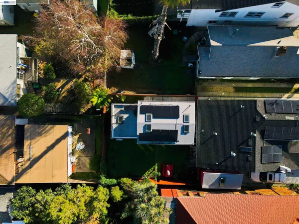 an aerial view of a house with a yard basket ball court and outdoor seating