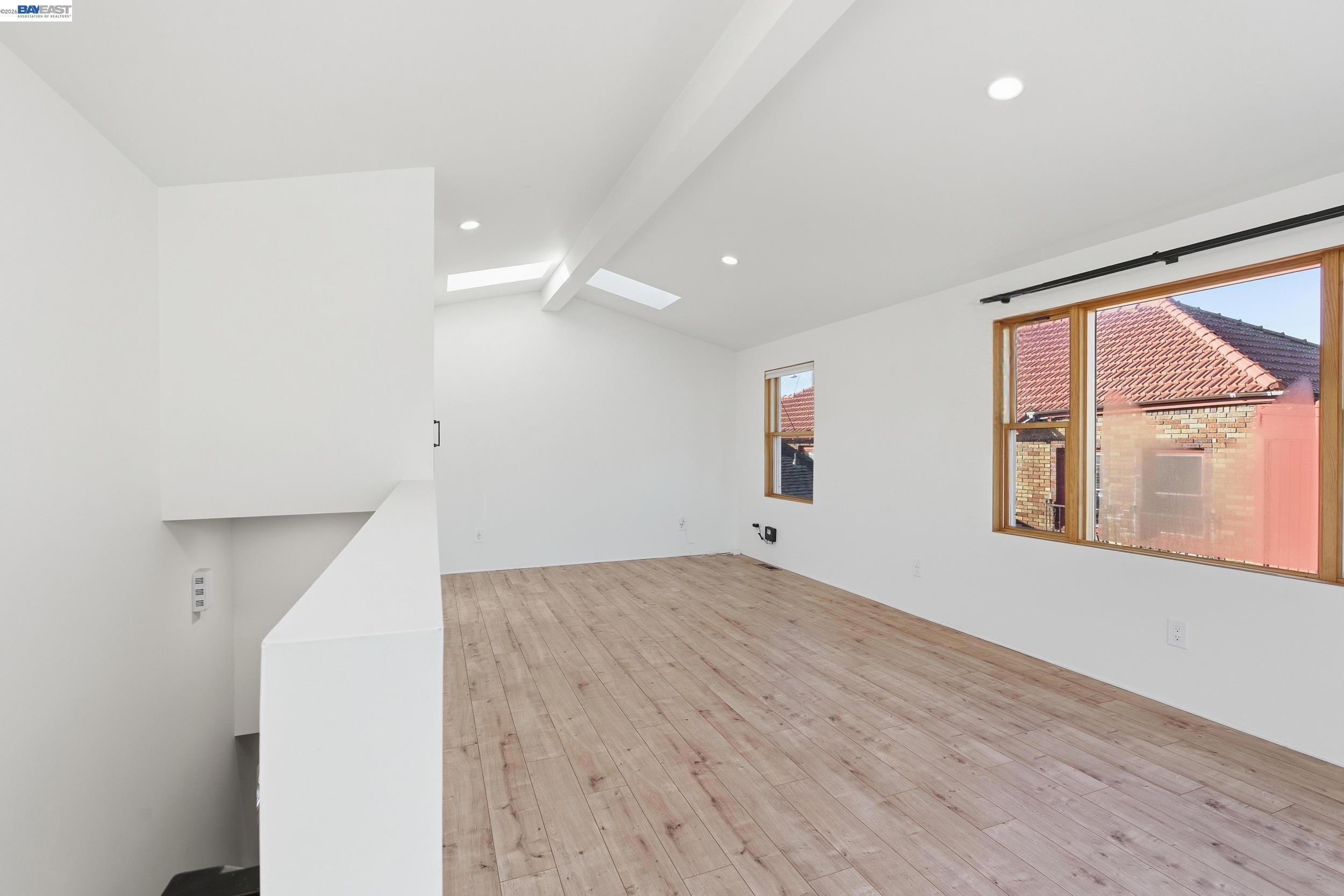 820 46th Street Oakland, CA 94608 - Photo 33 of 34 a view of an empty room with a window and wooden floor
