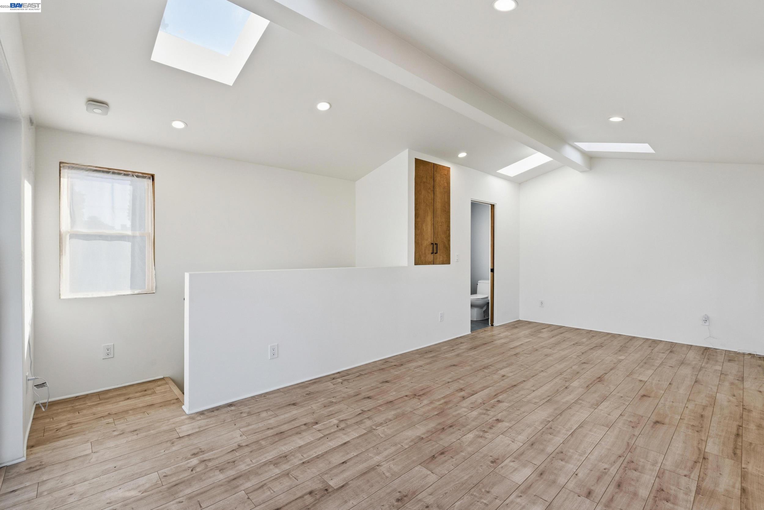 820 46th Street Oakland, CA 94608 - Photo 34 of 34 an empty room with wooden floor and windows