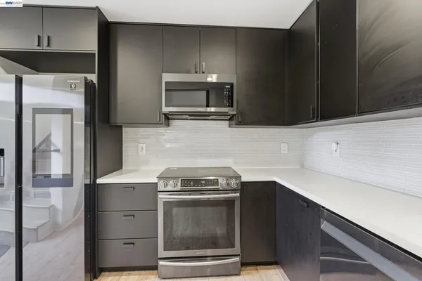 a kitchen with a stove microwave and sink
