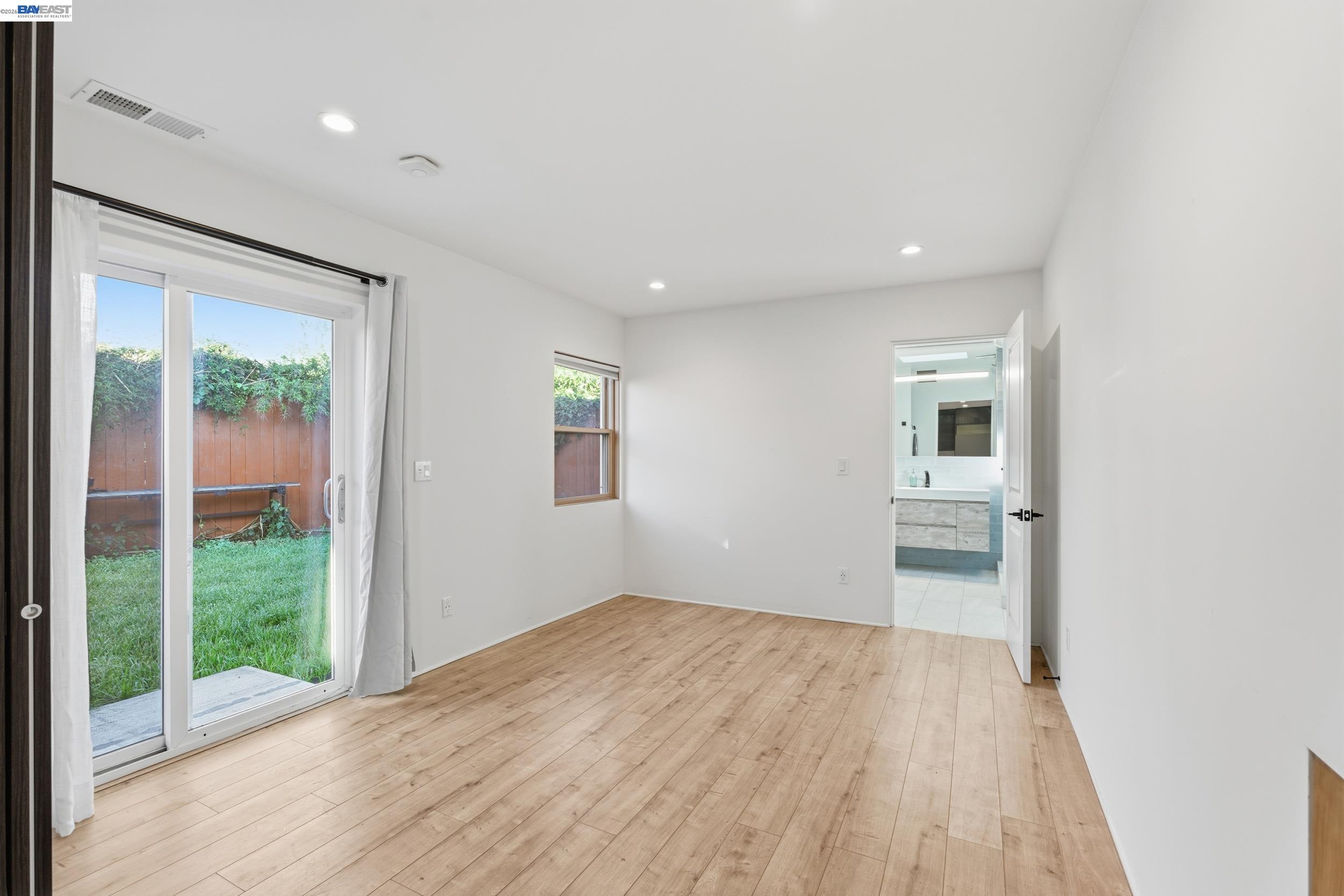 820 46th Street Oakland, CA 94608 - Photo 9 of 34 wooden floor in an empty room with a window