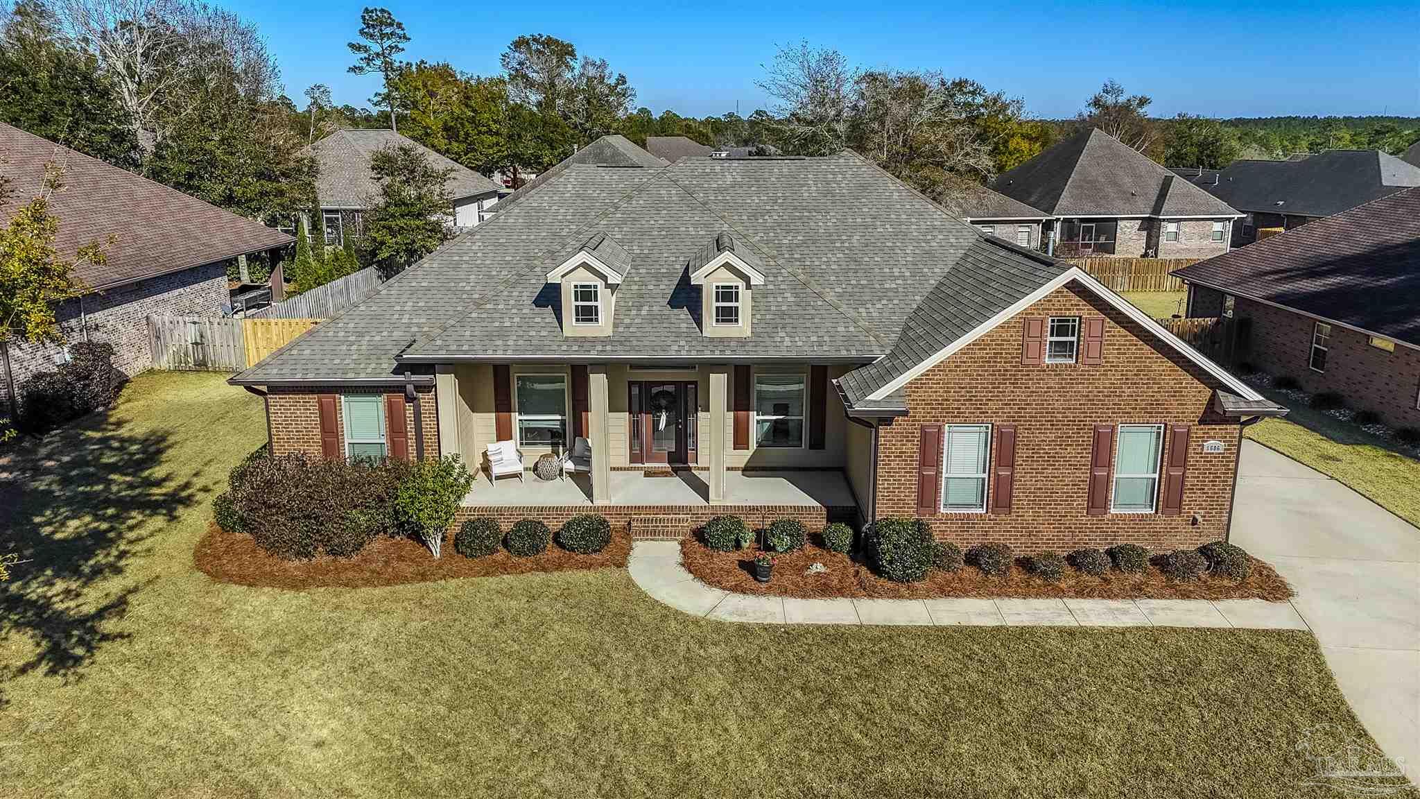 8606 Foxtail Loop Pensacola, FL 32526 - Photo 1 of 57 a front view of house with yard and trees in the background