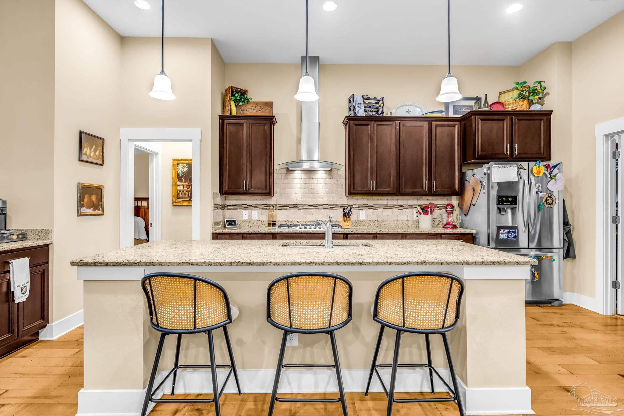 8606 Foxtail Loop Pensacola, FL 32526 - Photo 11 of 57 a kitchen with stainless steel appliances granite countertop a stove a sink and a refrigerator