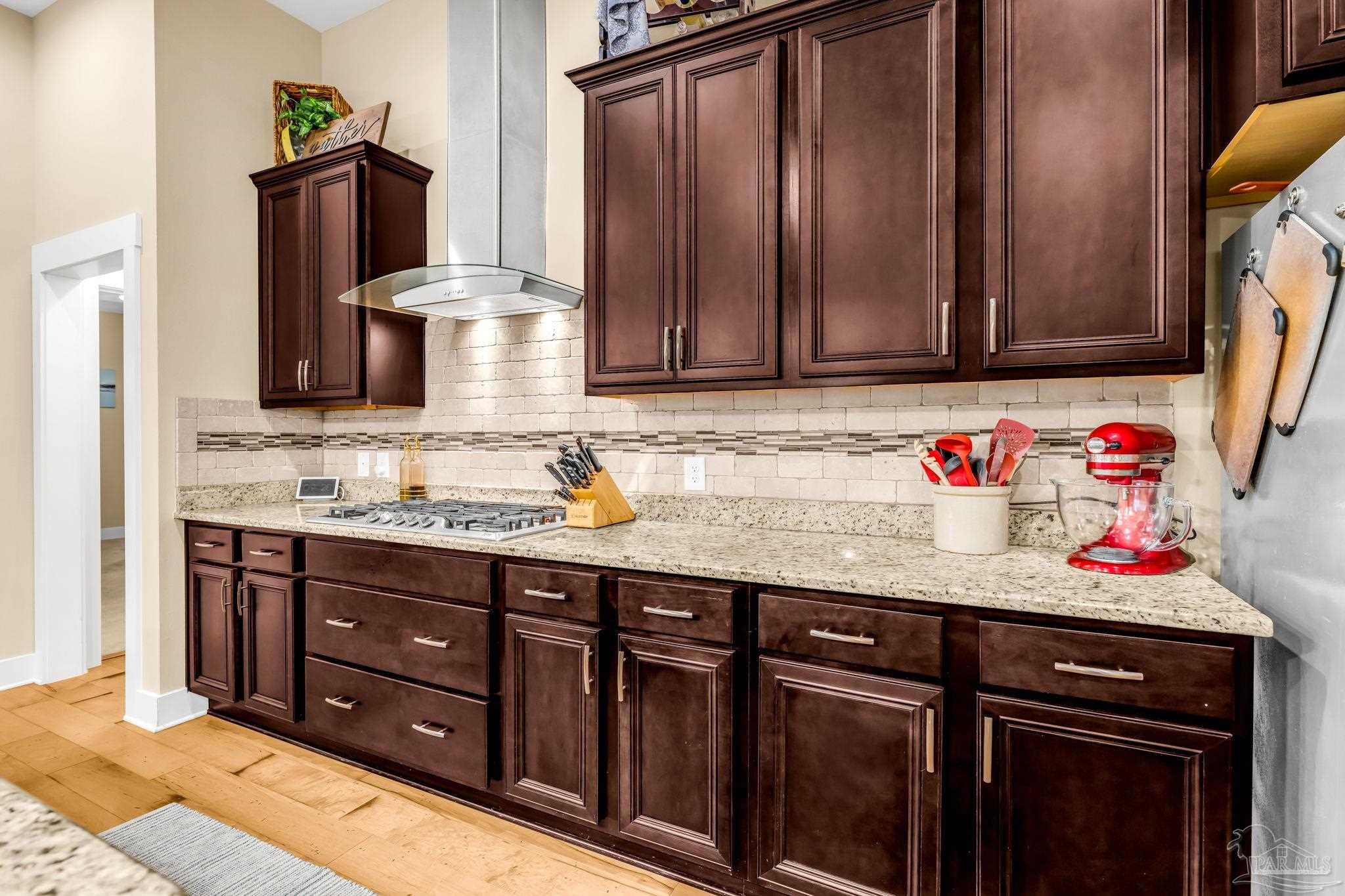 8606 Foxtail Loop Pensacola, FL 32526 - Photo 13 of 57 a kitchen with granite countertop a sink cabinets and appliances