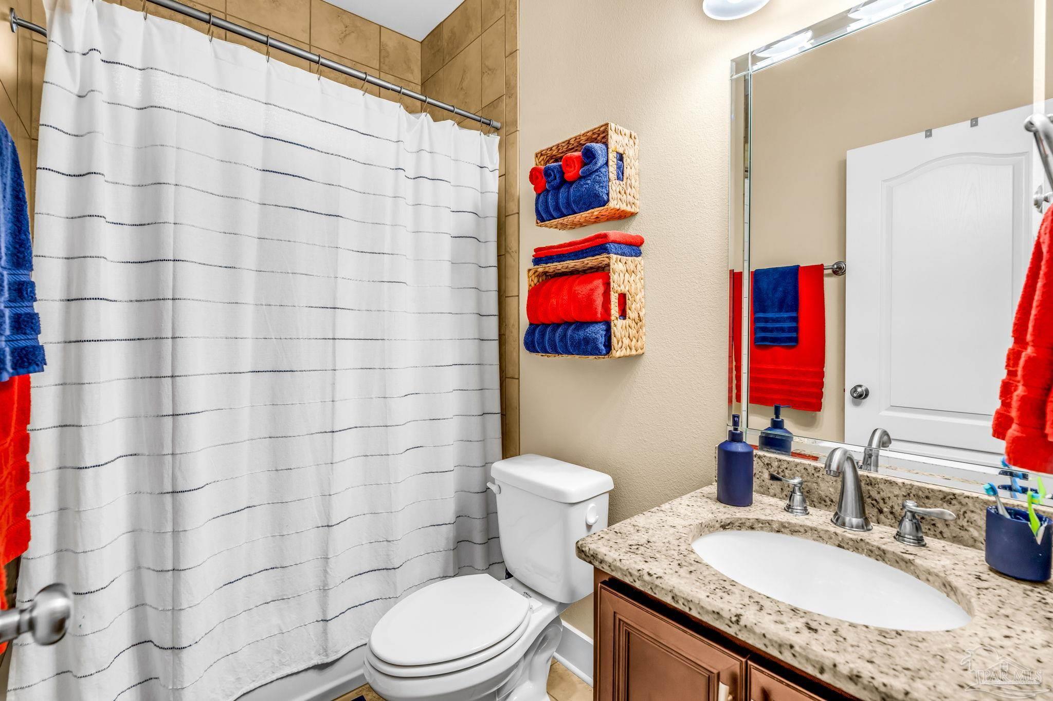 8606 Foxtail Loop Pensacola, FL 32526 - Photo 23 of 57 a bathroom with a granite countertop toilet sink and shower