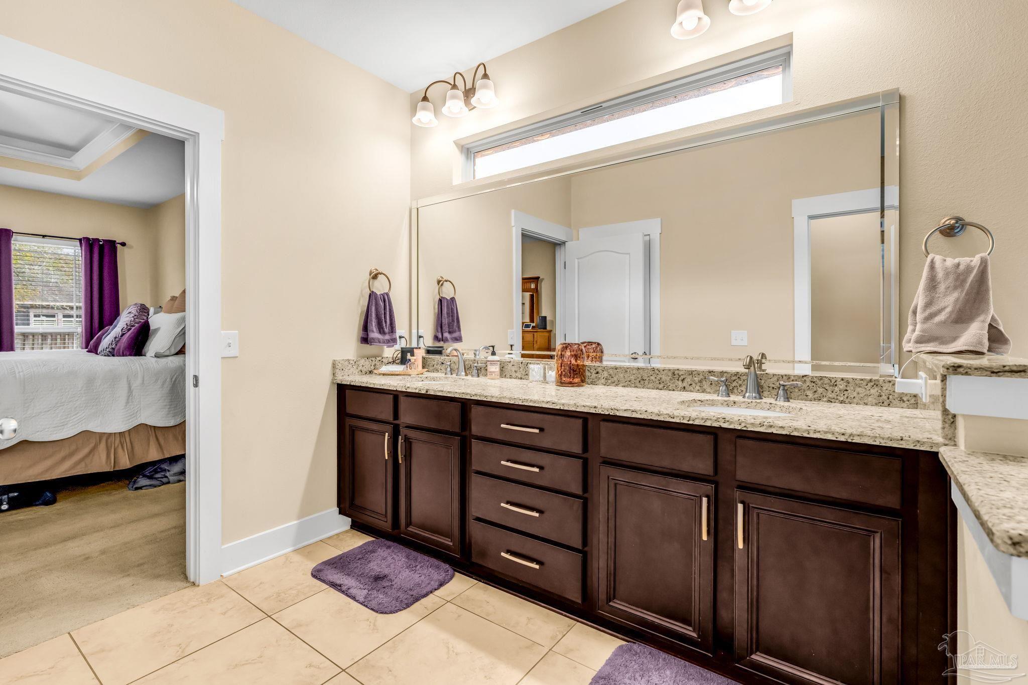 8606 Foxtail Loop Pensacola, FL 32526 - Photo 26 of 57 a en suite bathroom with a sink double vanity and a mirror