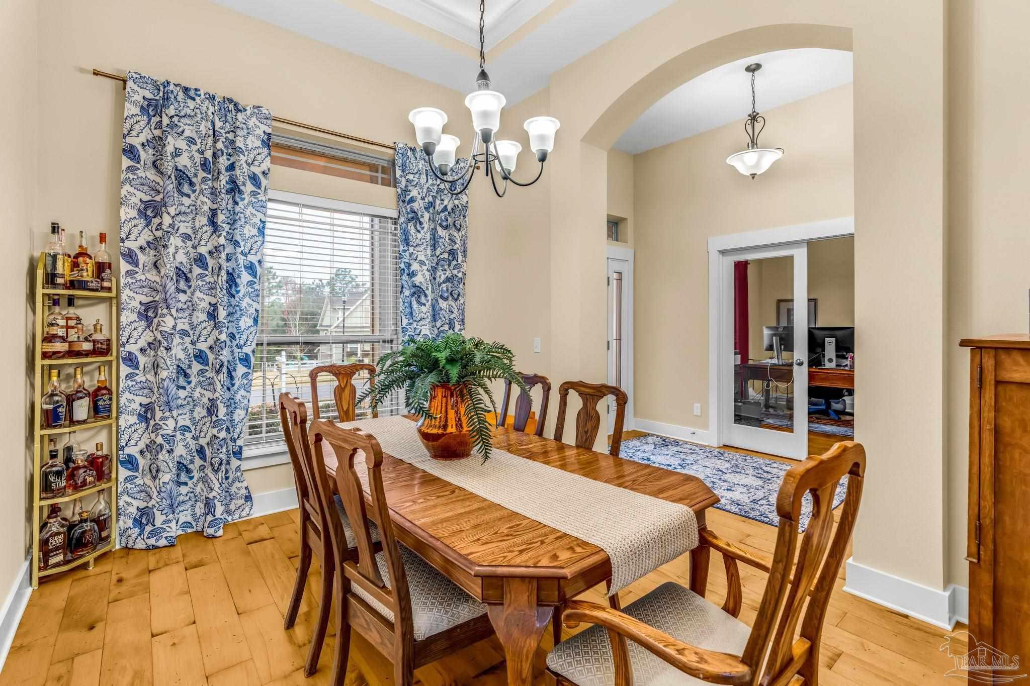 8606 Foxtail Loop Pensacola, FL 32526 - Photo 3 of 57 a view of a dining room with furniture and chandelier