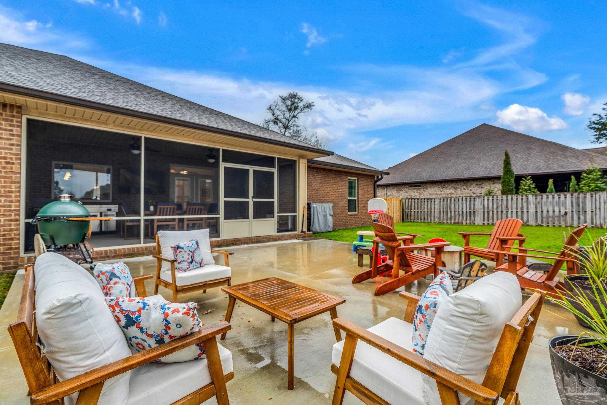 8606 Foxtail Loop Pensacola, FL 32526 - Photo 35 of 57 a view of a patio with table and chairs under an umbrella