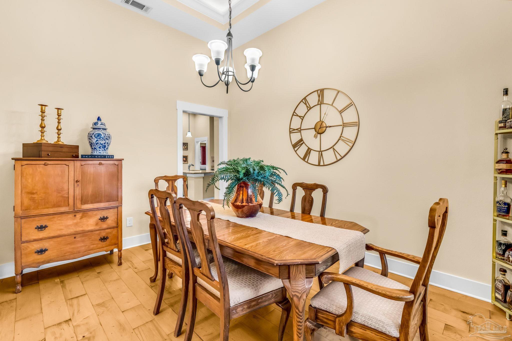 8606 Foxtail Loop Pensacola, FL 32526 - Photo 4 of 57 a view of a dining room with furniture and chandelier