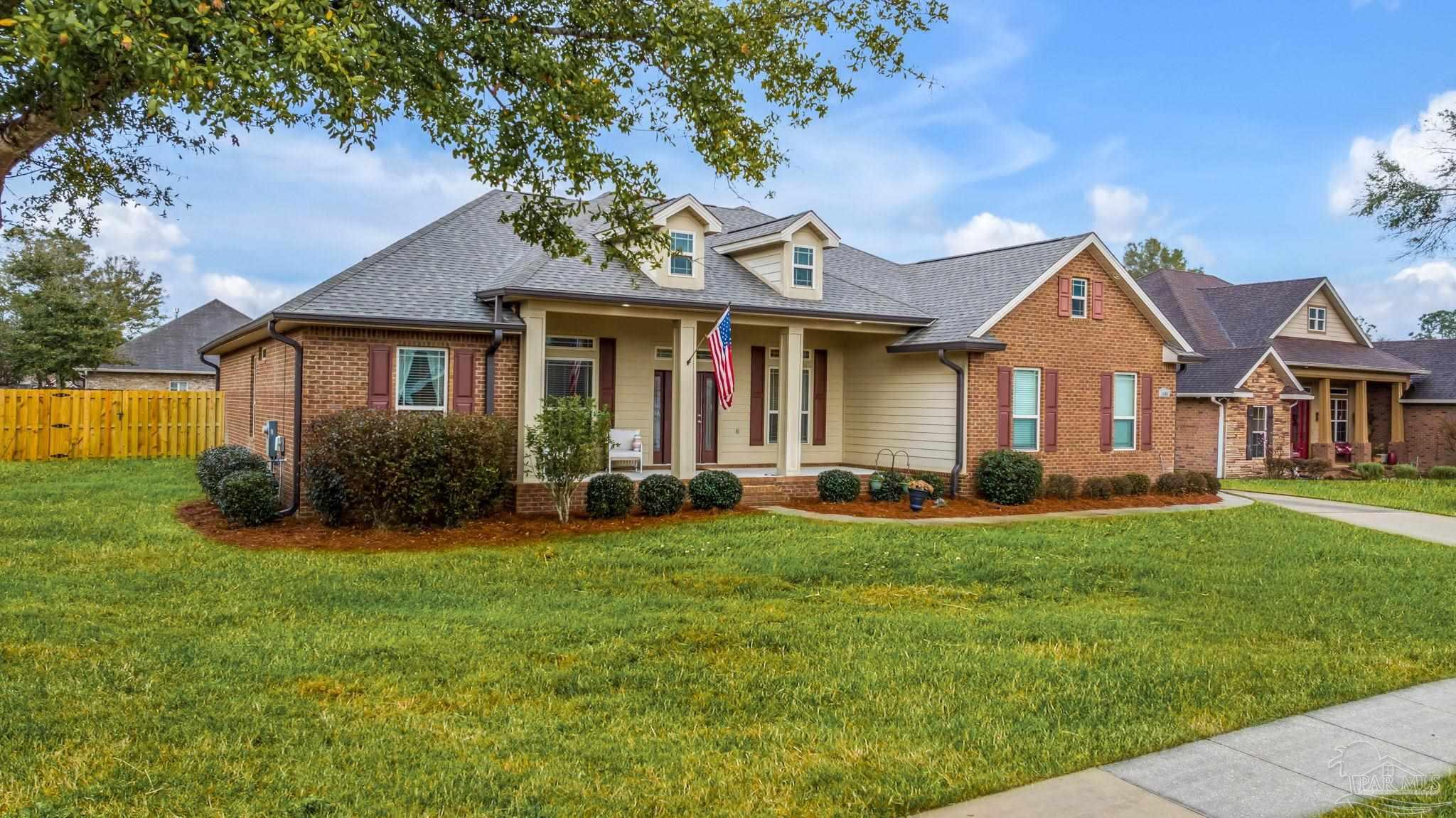8606 Foxtail Loop Pensacola, FL 32526 - Photo 41 of 57 a front view of a house with a yard and porch