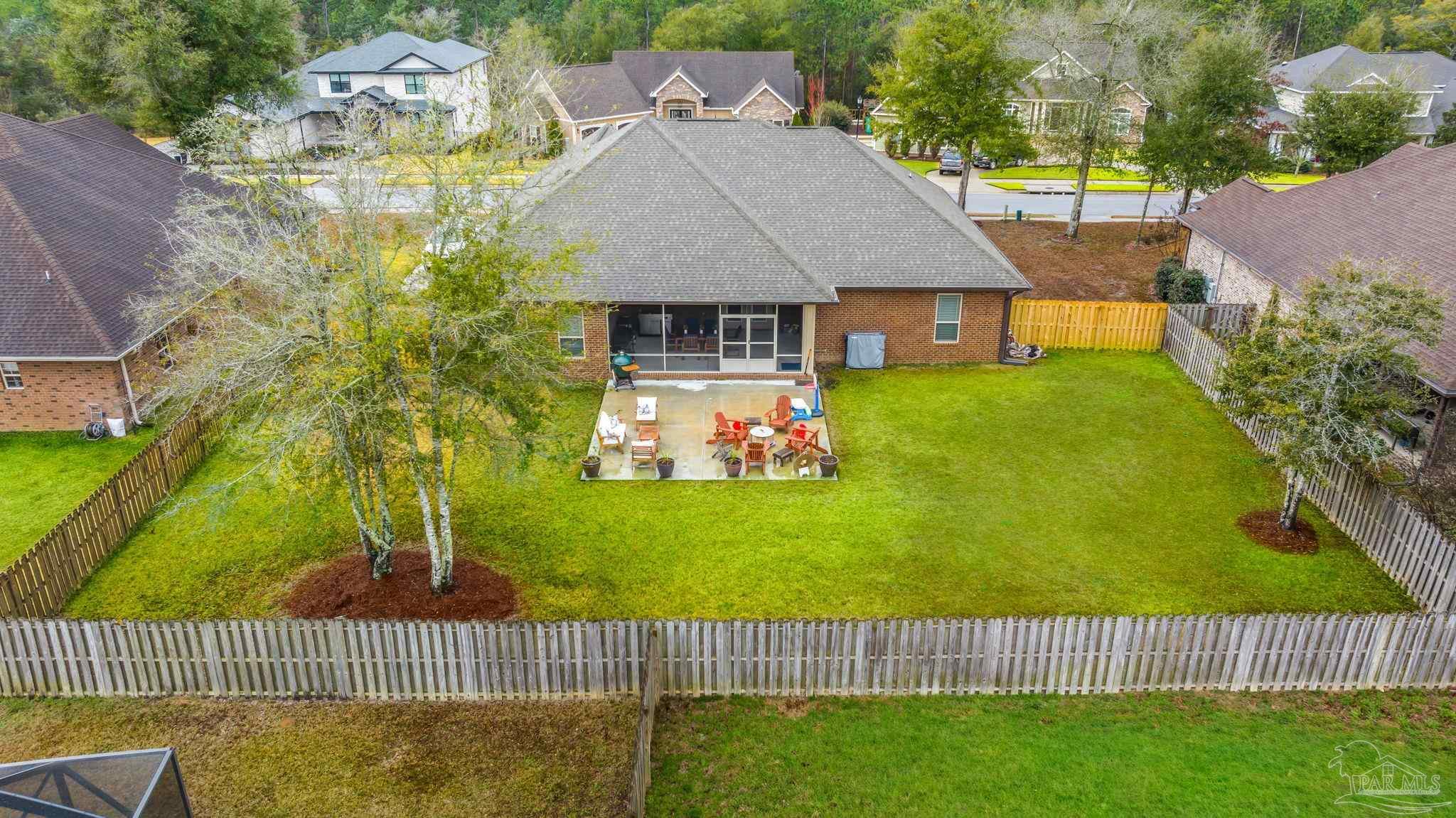 8606 Foxtail Loop Pensacola, FL 32526 - Photo 43 of 57 a aerial view of a house with table and chairs plants and large trees