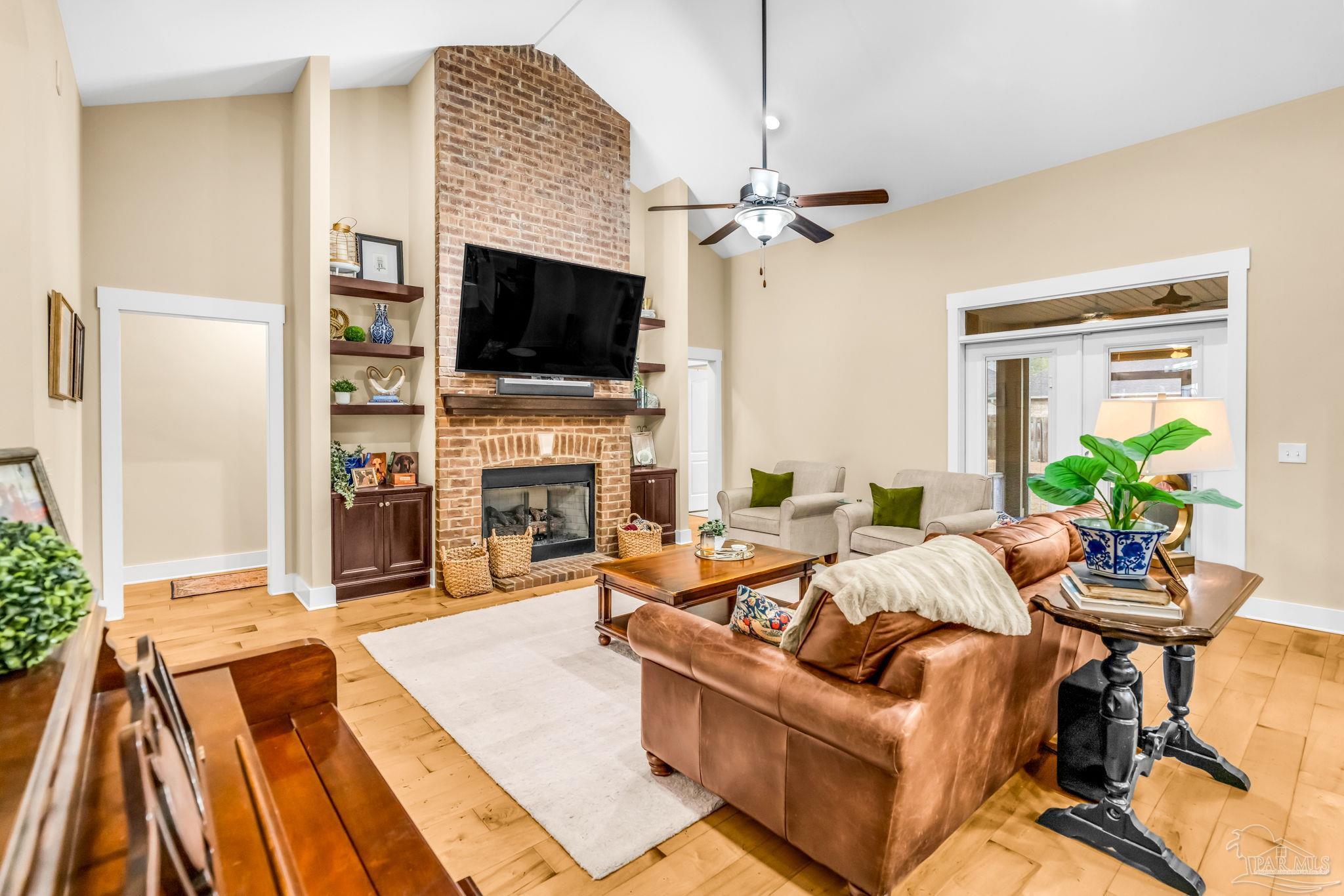 8606 Foxtail Loop Pensacola, FL 32526 - Photo 6 of 57 a living room with furniture a flat screen tv and a fireplace