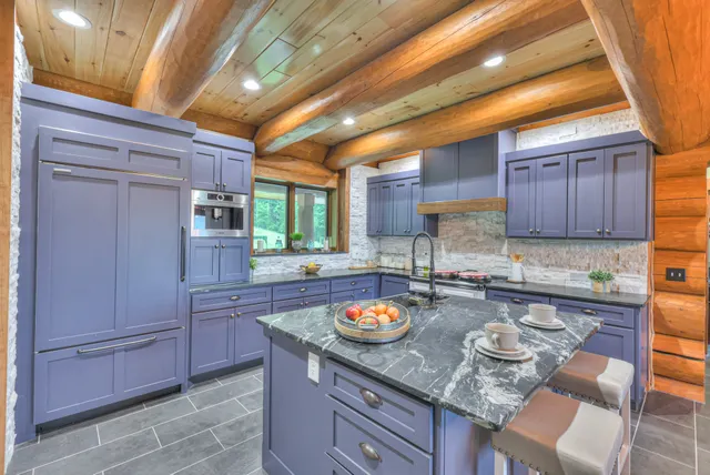 a kitchen with stainless steel appliances granite countertop a sink stove and cabinets