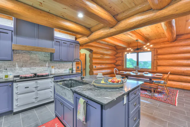 a kitchen with stainless steel appliances granite countertop a sink and a wooden cabinets