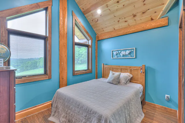 a bedroom with a bed and window