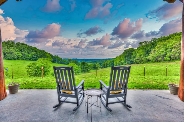 a backyard of a house with table and chairs