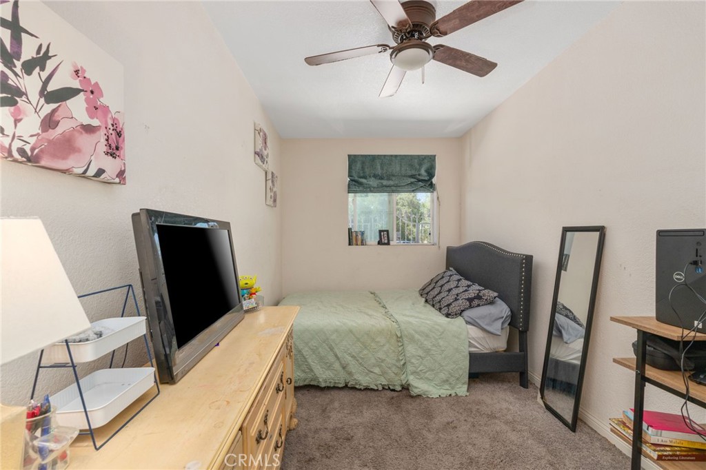 411 South Hewes Street Orange, CA 92869 - Photo 18 of 37 a bedroom with a bed a couch and a window