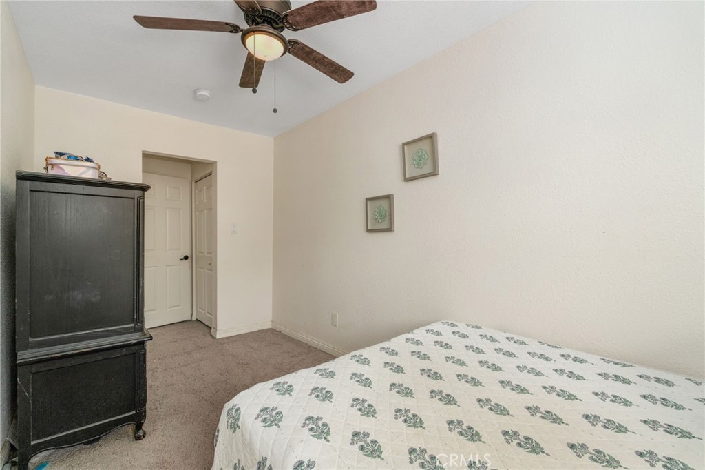 411 South Hewes Street Orange, CA 92869 - Photo 19 of 37 a bedroom with a bed and a chandelier fan