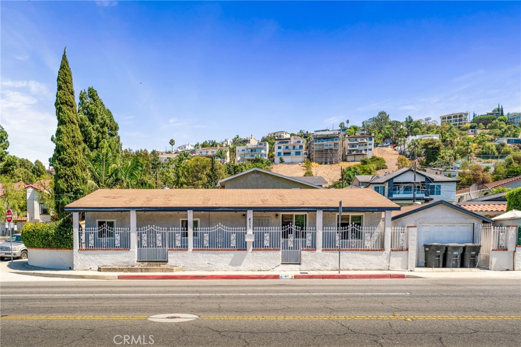 411 South Hewes Street Orange, CA 92869 - Photo 31 of 37 a front view of a house with a garden