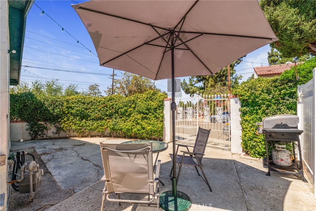 411 South Hewes Street Orange, CA 92869 - Photo 35 of 37 a patio with a patio table and chairs