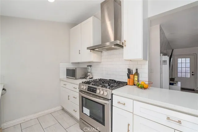 a view of a patio with table and chairs under an umbrella with a fire pit