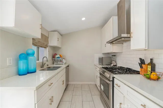 a kitchen with stainless steel appliances granite countertop a sink a stove and a granite counter tops