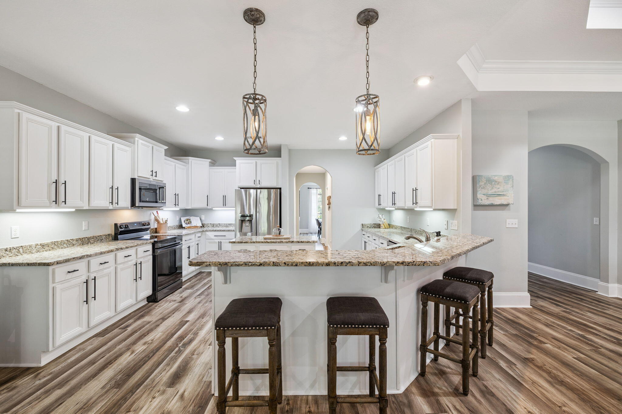 134 Mussett Bayou Court Santa Rosa Beach, FL 32459 - Photo 11 of 41 a kitchen with stainless steel appliances granite countertop a kitchen island a stove a table and chairs in it